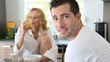 Video: Young couple having breakfast in home kitchen Young couple having breakfast in home kitchen