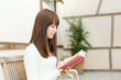 Beautiful young woman reading a book