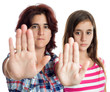 Latin women signaling to stop with their hands