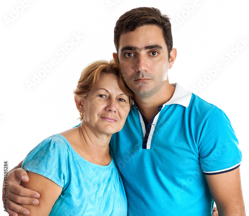Photo: Hispanic man hugging his mother isolated on white Hispanic man hugging his mother isolated on white