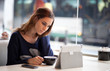 Candid image of a young woman using tablet computer