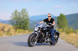 Man posing on a custom made motorcycle