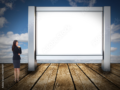 Photo: Business woman near billboard. Business woman near billboard.