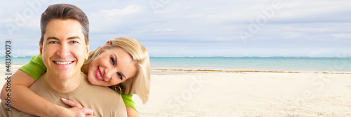 Photo: Happy couple on the beach. Happy couple on the beach.