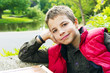 Cute teenage boy smiling against green background