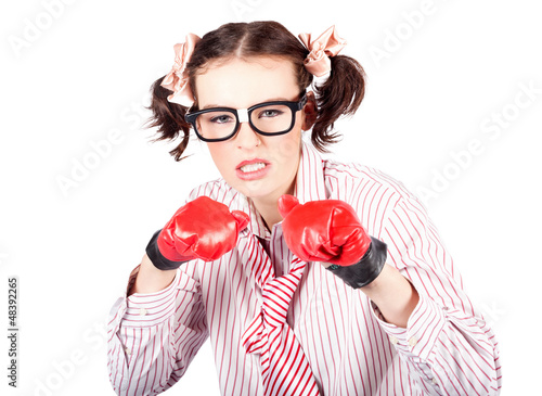 Photo: Determined young woman in boxing gloves Determined young woman in boxing gloves