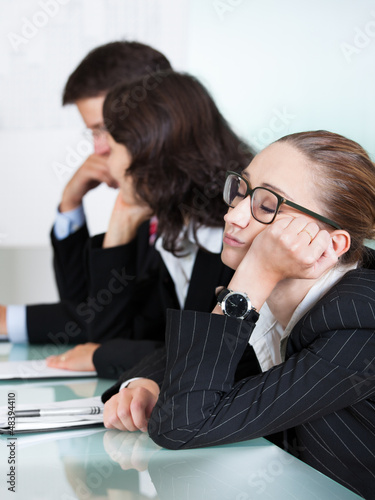 Photo: Bored businesswoman sleeping in a meeting Bored businesswoman sleeping in a meeting