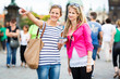 Two female tourists walking along the Charles Bridge
