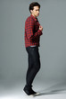 Full body handsome young man with plaid shirt denim jeans