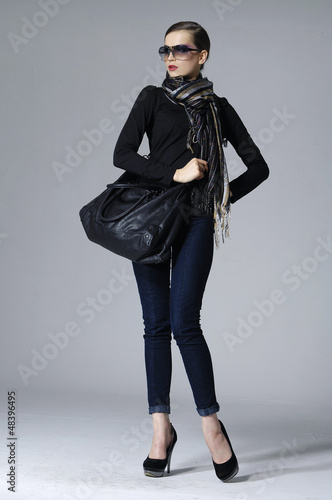 Photo: pretty woman with slim pose on gray background pretty woman with slim pose on gray background