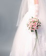 Wedding. Bouquet of roses in bride's hands.