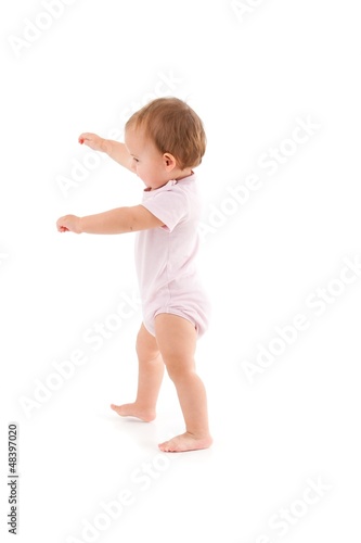Photo: Cute baby making first steps Cute baby making first steps