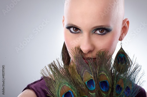 Photo: Bald woman with peacock plumes Bald woman with peacock plumes