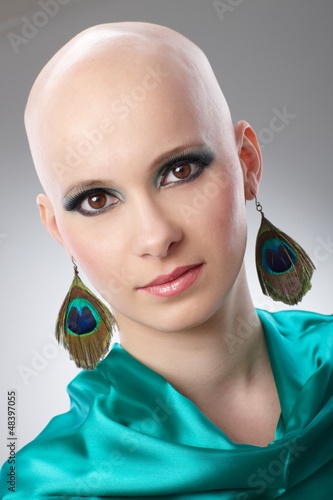 Photo: Portrait of hairless woman in turquoise silk dress Portrait of hairless woman in turquoise silk dress