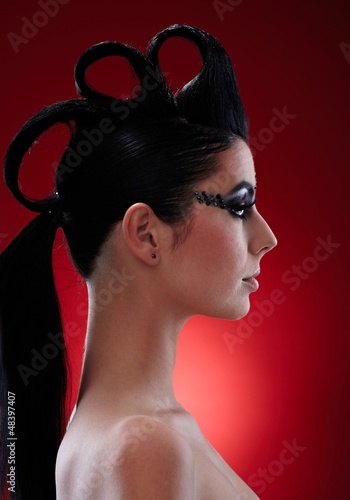 Photo: Woman with extravagant makeup and hairstyle Woman with extravagant makeup and hairstyle