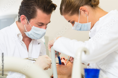 Photo: Patient with Dentist - dental treatment Patient with Dentist - dental treatment