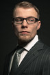 Fashion man in suit wearing glasses. Studio shot.
