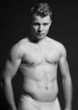 Muscled fitness man. Black and white studio shot.