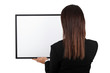 Woman back at the camera holding a frame.
