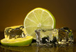 Ice cubes with lime on darck orange background