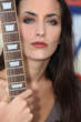 Unfriendly woman posing with her guitar