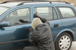 Robber with a crowbar trying to open the car door