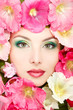 beautiful female face with pink, red and white mallow flowers fr