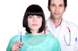Hospital doctor and nurse holding a sterile gauze