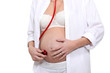 pregnant woman listening her baby with a stethoscope