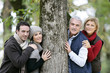 Photo: Two generations stood against tree Two generations stood against tree