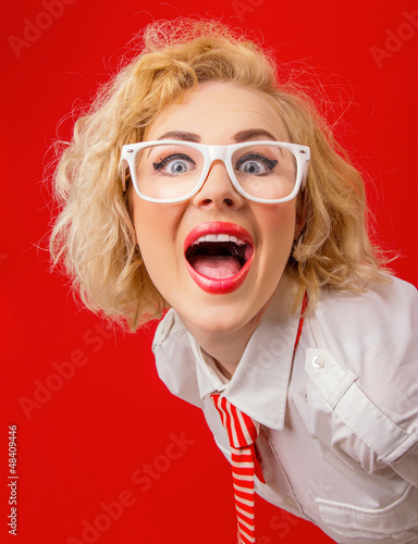 Photo: Close-up funny woman screaming, isolated on red background Close-up funny woman screaming, isolated on red background