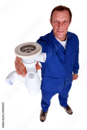 Photo: Plumber holding replacement sink plug Plumber holding replacement sink plug