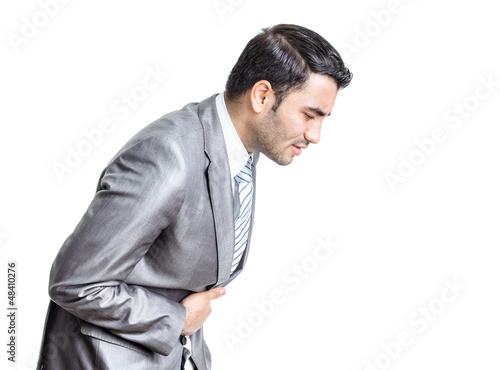 Photo: Business man with stomach ache with hands on abdomen Business man with stomach ache with hands on abdomen