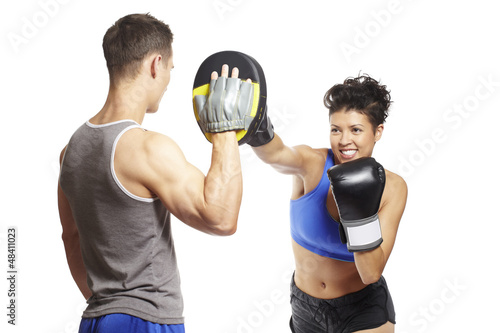 Photo: Young man and woman boxing sparring Young man and woman boxing sparring