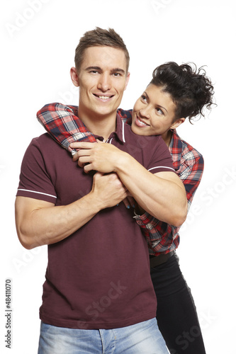 Photo: Young couple cuddling and smiling Young couple cuddling and smiling