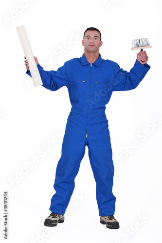 Photo: painter holding a brush and a wallpaper painter holding a brush and a wallpaper
