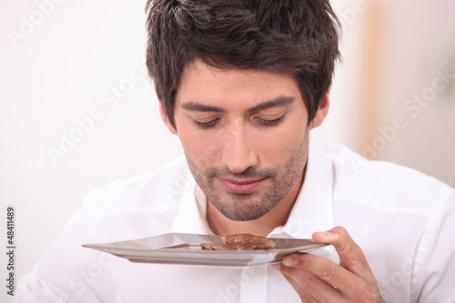 Photo: Businessman smelling food on plate Businessman smelling food on plate