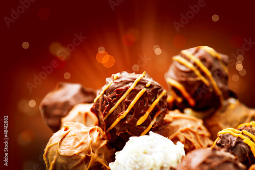 Photo: Assorted Chocolate Candies. Sweets. Candy Border Design Assorted Chocolate Candies. Sweets. Candy Border Design