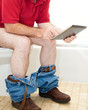 Photo: Man On Toilet with Tablet PC Man On Toilet with Tablet PC