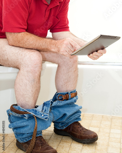 Photo: Man On Toilet with Tablet PC Man On Toilet with Tablet PC