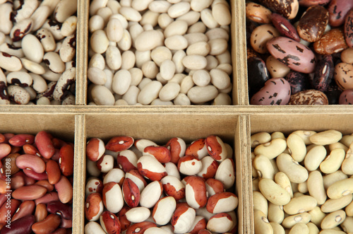 Photo: Diverse beans in wooden box sections close-up Diverse beans in wooden box sections close-up