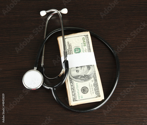 Photo: Healthcare cost concept: stethoscope and dollars Healthcare cost concept: stethoscope and dollars