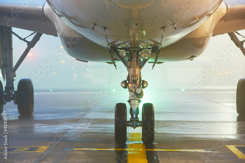 Photo: Undercarriage of the airplane - Airport at the night Undercarriage of the airplane - Airport at the night