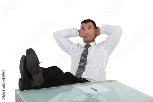 Photo: Businessman resting feet on desk Businessman resting feet on desk