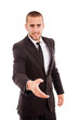 Smiling young businessman with an open hand ready to seal a deal