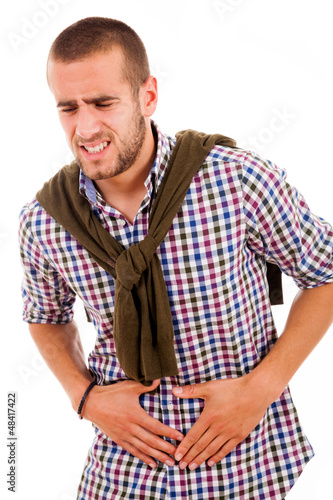 Photo: Young man with strong stomach pain isolated on white background Young man with strong stomach pain isolated on white background