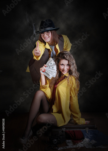 Photo: Two fashionable girls portrait in gangster style Two fashionable girls portrait in gangster style