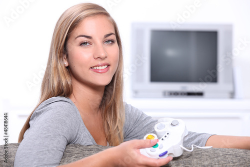 Photo: Young woman on games console Young woman on games console