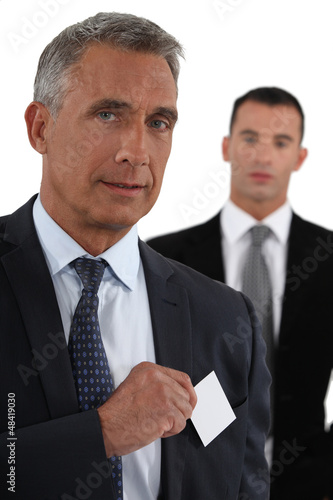 Photo: Executive with a blank business card Executive with a blank business card