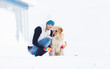 Photo: Girl in winter suit on a walk with her labrador. Girl in winter Girl in winter suit on a walk with her labrador. Girl in winter